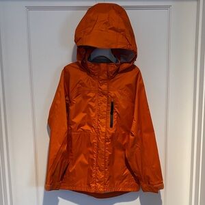 REI lightweight rain jacket with roll up hood in size XS (6 - 7)